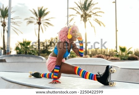 Beautiful woman skating with roller skates and having fun. Professional skater and dancer training in the morning wearing colored and fashionable clothes.