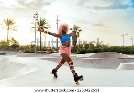 Beautiful woman skating with roller skates and having fun. Professional skater and dancer training in the morning wearing colored and fashionable clothes. Royalty-Free Stock Photo #2250422611