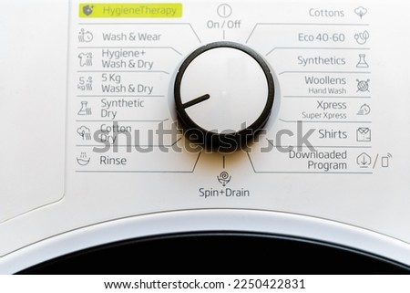 White clothes dryer washing machine dial control panel with rotation knob and various program names in Dutch. Royalty-Free Stock Photo #2250422831