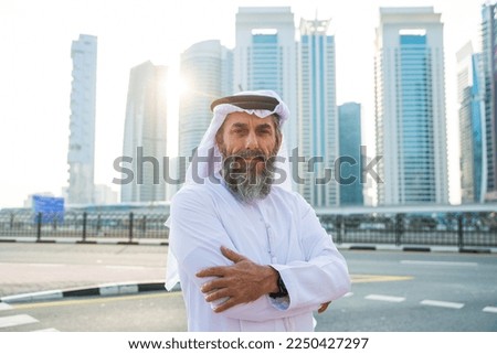 Senior man wearing kandura traditional dress from uae in Dubai Royalty-Free Stock Photo #2250427297