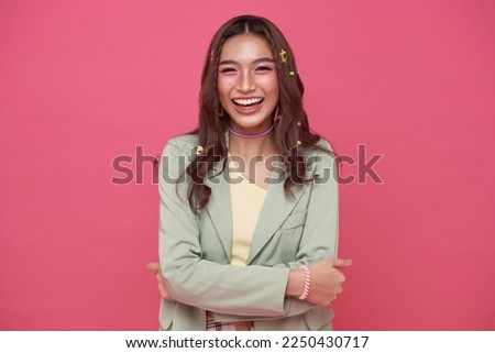 Happy cheerful young woman laugh looking at camera with joyful and charming smile isolated on pink studio background.