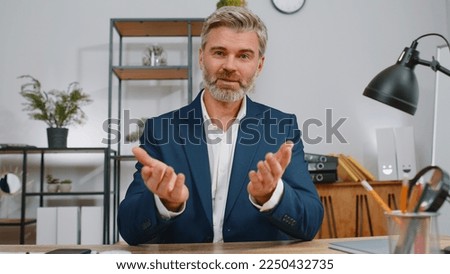 POV video screen view of businessman working at home office desk talk online communication video webcam call with employee, boss, colleague. Mature man freelancer support services looking at camera Royalty-Free Stock Photo #2250432735