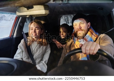 Family travelling by car in winter