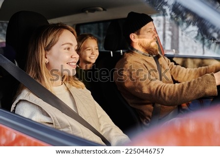 Family of three travelling by car
