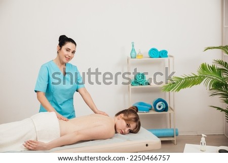 female masseur does therapeutic spa massage