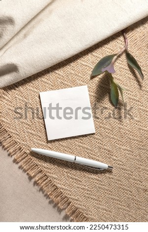 Neutral beige background with a blank paper card sheet with empty mock up copy space. Aesthetic minimalist blog, social media, workspace template