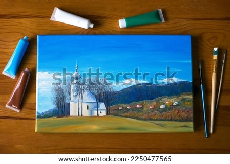 Acrylic painting of church in the  mountain village Labowa in Poland, at the beautiful mountain scenery background, top view