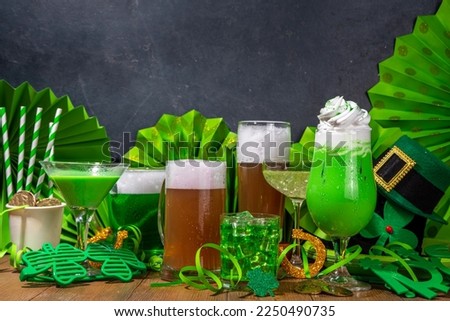 St Patrick's Day bar menu background. Set various golden, green beer glasses, different cocktails and drinks, with St. Patrick's Day party decor and accessories, on dark wooden background