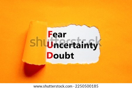 FUD fear uncertainty doubt symbol. Concept words FUD fear uncertainty doubt on white paper on a beautiful orange background. Business and FUD fear uncertainty doubt concept. Copy space.