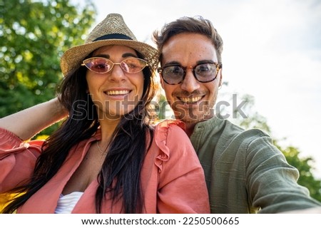 Young lovers selfie outdoor, backlight and nature background