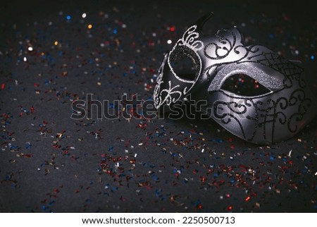 Venetian carnival mask with black glitter background. Carnival and Mardi Gras party celebration design background