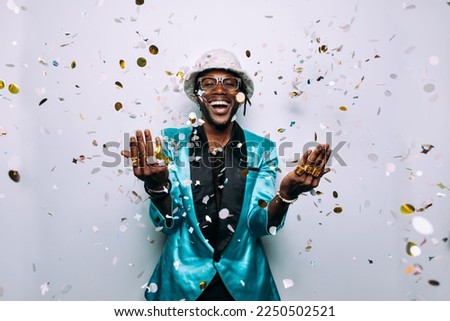 portrait of an hip hop music musician. Cinematic image of a man under confetti drop