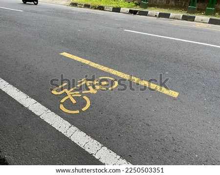 Empty bicycle track on the asphalt street with bicycle icon.