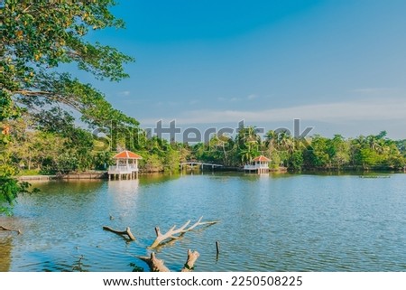 Scenic landscape view with reflection of lake against blue sky background of Sri Nakhon Khuean Khan Park and Botanical Garden in Bang Kachao, Samut Prakan, Thailand - The Green lung area in Bangkok Royalty-Free Stock Photo #2250508225