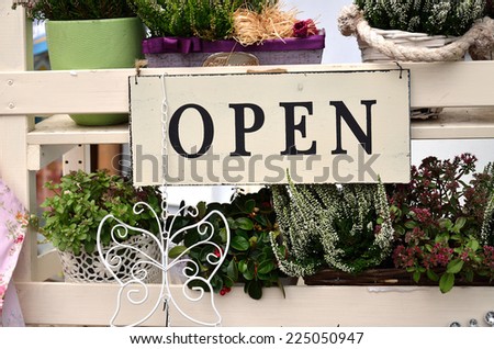 Open - to the World of Flowers / Interesting banner outside the shop with flower and tools 