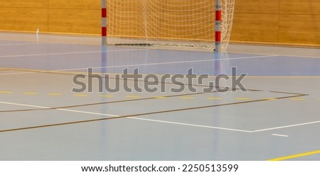 Handball goal and hall floor in a sports hall with various lines