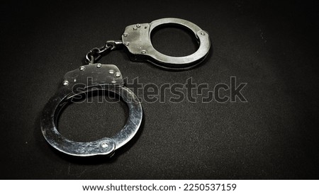 Handcuffs on a black endless background.