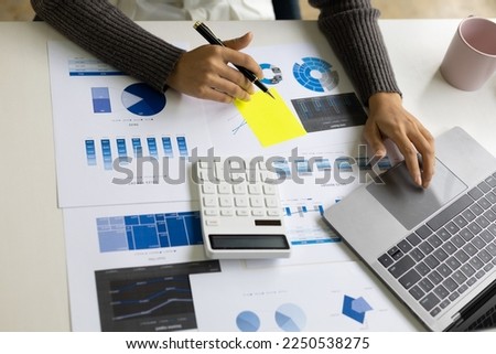Business woman in office working on laptop reading financial account report, statistic, accounting analysis.