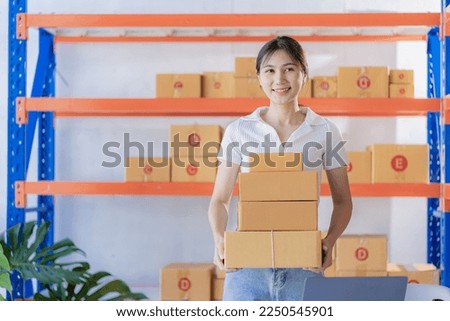 Asian girl using laptop and working at home Entrepreneurs, small businesses, start-ups, delivery boxes, online marketing, SMEs.