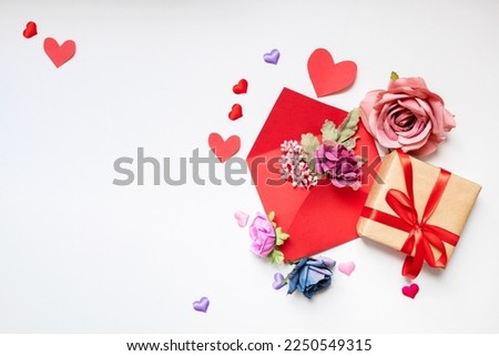 classic valentine's day background with hearts,envelope, flowers and gifts on white background. copy space. top view