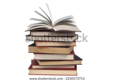 Stacked books with open book on top on white background