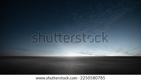 Black Asphalt Floor Background with Dark Blue Night Sky Sunset Horizon and Subtle Clouds Royalty-Free Stock Photo #2250580785
