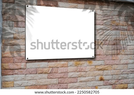 Blank picture frame on brick wall with copy space, framed poster mockup. Distressed red brick wall texture grunge background. Empty picture frame, banner or billboard