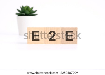 E2E Exchange to Exchange acronym on wooden cubes on white background. business concept
