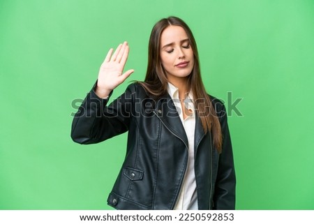 Young beautiful woman over isolated chroma key background making stop gesture and disappointed Royalty-Free Stock Photo #2250592853
