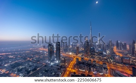 Aerial panoramic view of tallest towers in Dubai Downtown skyline night to day transition  before sunrise. Financial district and business area in smart urban city. Skyscraper and high-rise buildings Royalty-Free Stock Photo #2250606675