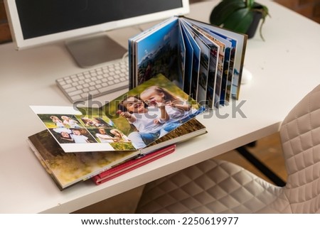 Family photos archive saved in brightly designed photo book, bright summer memories placed in the photobook