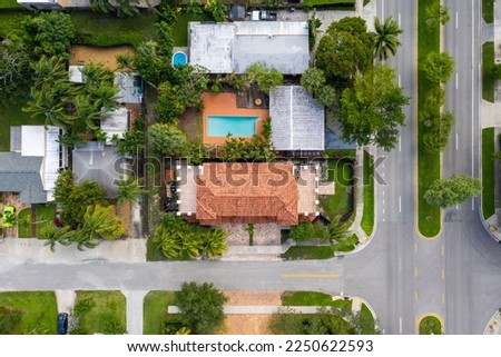 Aerial drone shot of elegant colonial style houses in the Croissant Park neighborhood of Fort Lauderdale, tropical vegetation around,