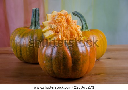 Pictured woman shows how to make a Halloween pumpkin.