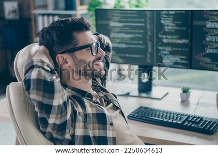 Profile photo of satisfied glad cybersecurity expert sitting chair hands behind head open space workplace indoors