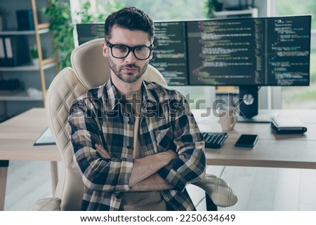 Photo of serious focused web designer guy sitting chair crossed arms database optimization workplace open space indoors