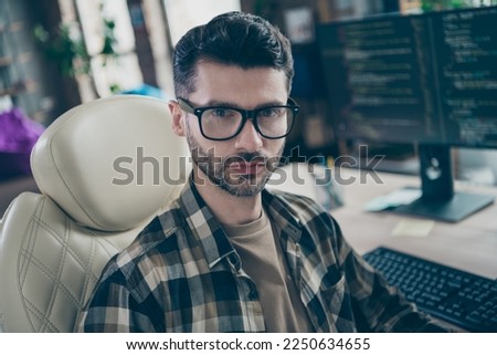 Photo of serious concentrated cybersecurity expert man sitting leather chair operating database open space indoors