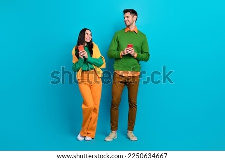 Photo of two bloggers guy lady communicate gadget search facebook instagram friends request isolated blue color background Royalty-Free Stock Photo #2250634667