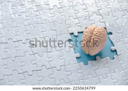 Concept of autism, memory loss, dementia and alzheimer awareness, world mental health day. brain model inside a missing piece of puzzle.