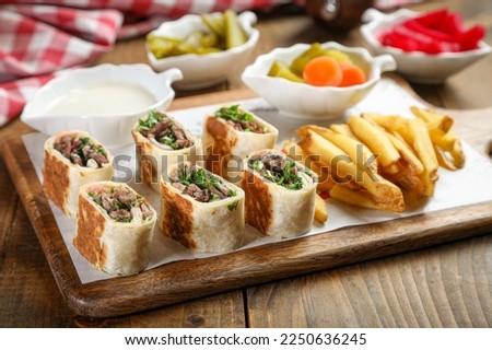 Shawarma beef sandwich fresh roll of, Grilled Meat and salad tortilla wrap with white sauce
 Royalty-Free Stock Photo #2250636245