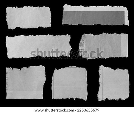 Seven pieces of torn newspaper on black background Royalty-Free Stock Photo #2250655679