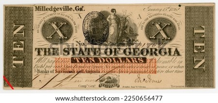 Ten-dollar bill issued by Georgia during the Civil War featuring female figure in field. Beige, orange, and black. Hand-cut, hand-signed, and hand-cancelled. Red line added post-production. Royalty-Free Stock Photo #2250656477