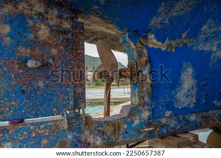 boat bottom and propeller covered in barnacle Royalty-Free Stock Photo #2250657387