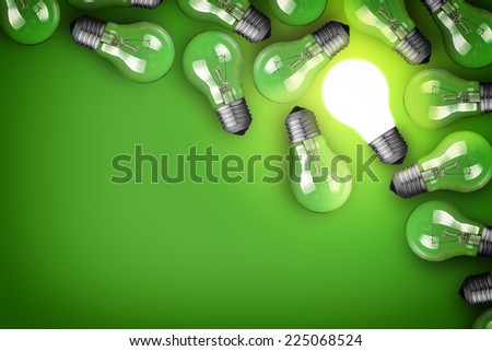 Idea concept with light bulbs on green background