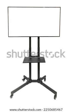 A big flat-screen TV on a tall rolling stand, isolated on white with copy space.  The screen of the TV is blank white so you can drop in your image or copy. Royalty-Free Stock Photo #2250685467