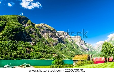 Typical wooden red buildings next to Sognefjord in Norway Royalty-Free Stock Photo #2250700701
