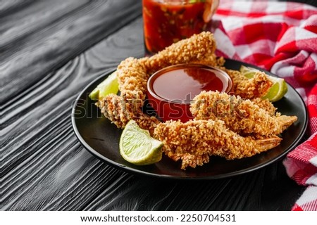 delicious crispy panko shrimp on a black wooden rustic background. Royalty-Free Stock Photo #2250704531