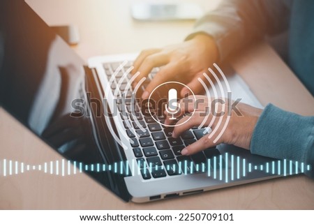 Businessman using laptop with microphone button on virtual screen. Blog blog speak talk advertising presentation, Voice recognition, speech detection and deep learning application,Voice Assistance Royalty-Free Stock Photo #2250709101