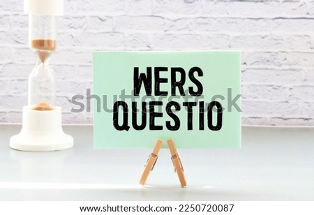 On a wooden table are two wooden blocks with the text question WE ARE HIRING.