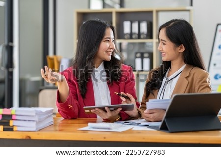 Asian female sales representatives in the section of Real estate talked and discussed tax plans to search for information Ask questions and give advice. All information is recorded and detailed. 

