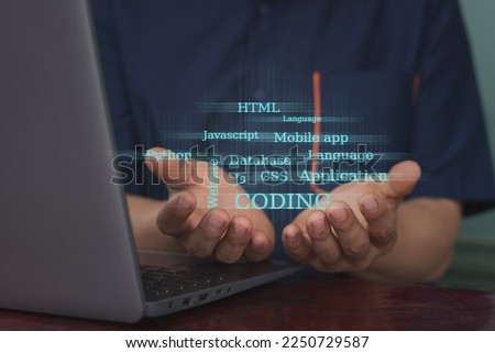 The hands holding coding and related text computer effect, machine learning and computer coding command concept, copy space for individual text and design